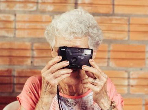 Lady Looking Through Camera Lens