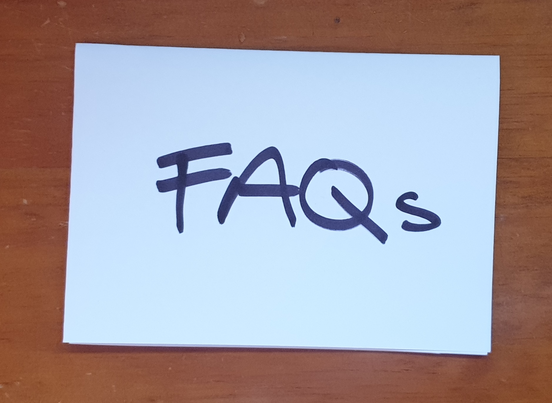 FAQs note on wooden desk